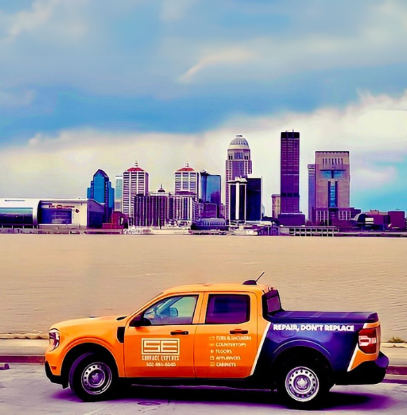 Image of an orange truck in front of the skyline