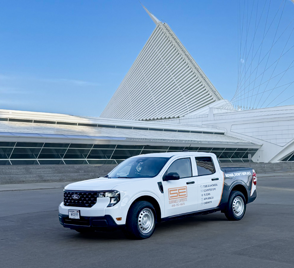 Photo of white branded Surface Experts truck parked in front of the Milwaukee Art Museum